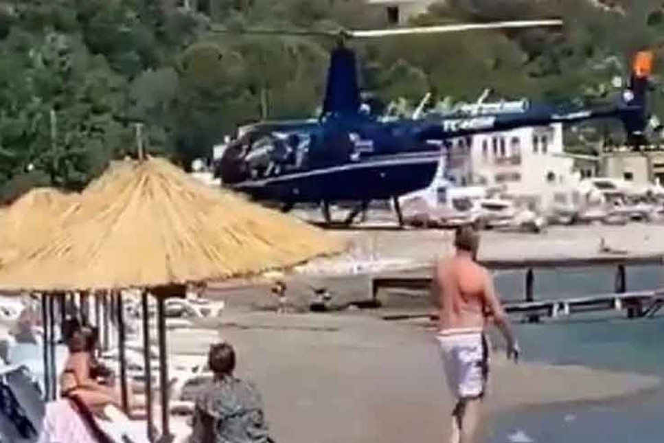 Marmaris'te iki iş insanı yemek için halk plajına helikopterle iniş yaptı